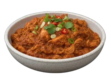 Chicken Tinga in a shallow bowl with chilli and herbs.