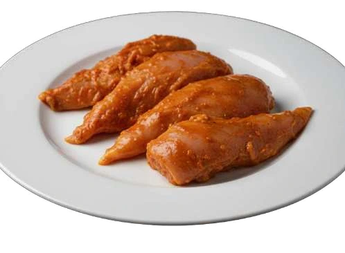 Pollo Asado marinated chicken breast on a white plate.